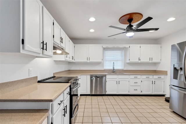 kitchen featuring sink, ceiling fan, light tile patterned floors, appliances with stainless steel finishes, and white cabinetry