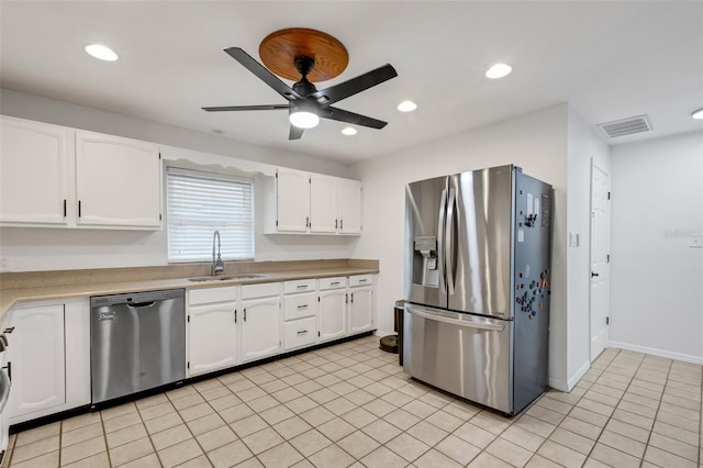 kitchen with white cabinetry, sink, ceiling fan, light tile patterned floors, and appliances with stainless steel finishes