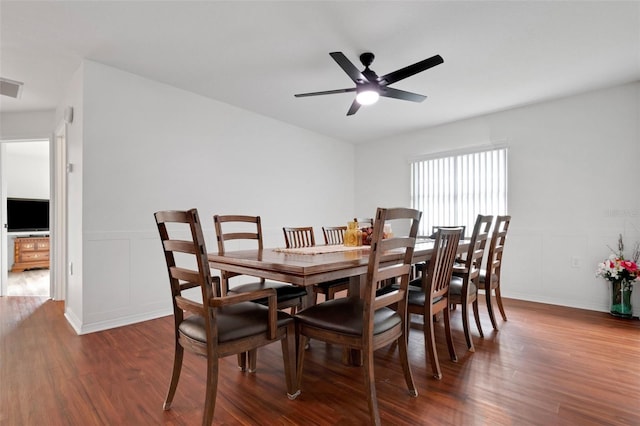 dining area with ceiling fan and dark wood-type flooring