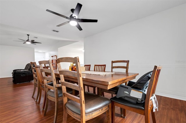 dining space with dark hardwood / wood-style floors and ceiling fan