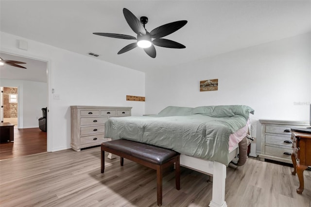 bedroom featuring connected bathroom, light hardwood / wood-style floors, and ceiling fan