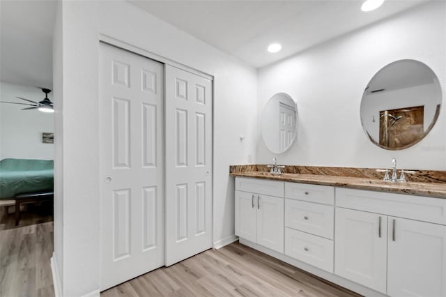 bathroom featuring hardwood / wood-style floors, ceiling fan, and vanity