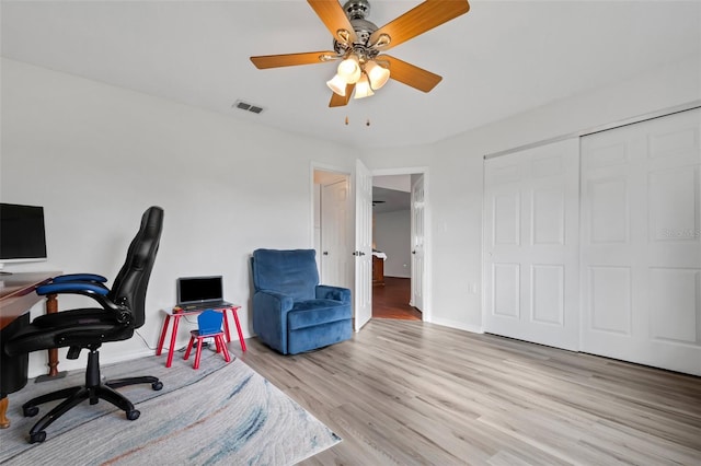 office space with ceiling fan and light wood-type flooring