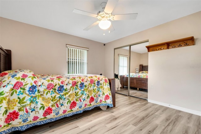 bedroom featuring ceiling fan, a closet, and light wood-type flooring