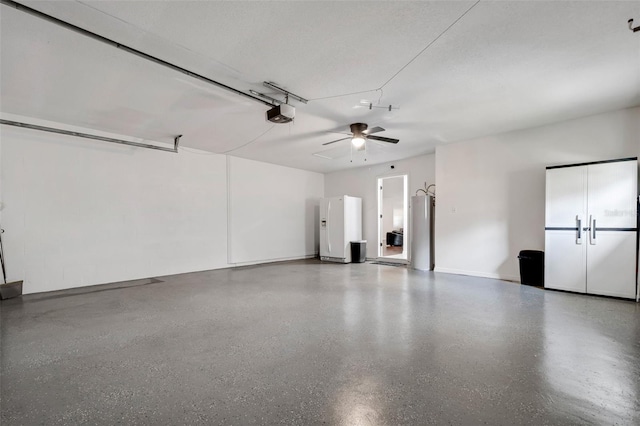 garage featuring ceiling fan, white fridge with ice dispenser, a garage door opener, and gas water heater