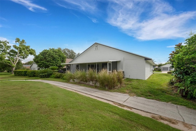 view of side of property with a lawn