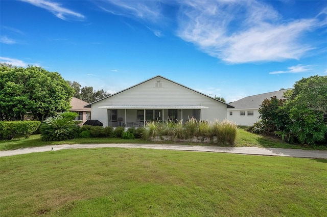 ranch-style home with a front lawn and a sunroom