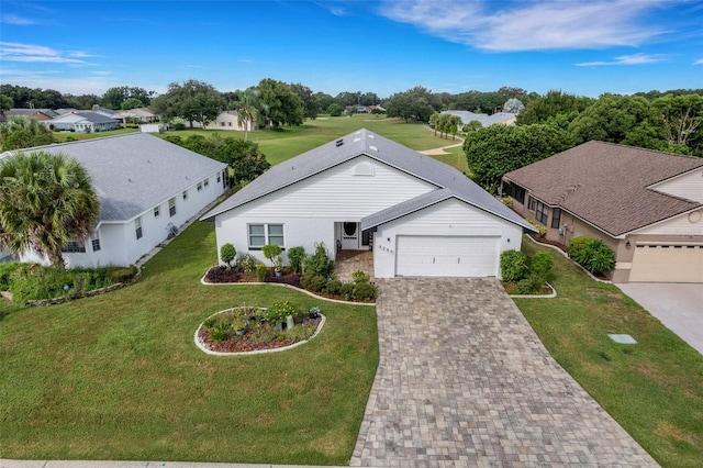 view of front of home with a front yard and a garage