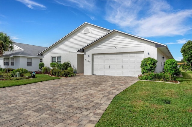 ranch-style home with a front yard and a garage