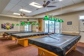 game room with a paneled ceiling, carpet floors, ceiling fan, and pool table