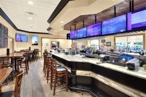 bar featuring hardwood / wood-style floors and ornamental molding