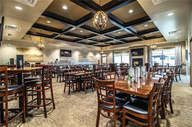 dining area featuring beam ceiling, light colored carpet, coffered ceiling, and an inviting chandelier