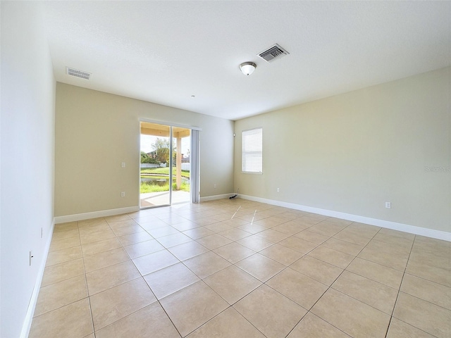 unfurnished room featuring light tile patterned floors