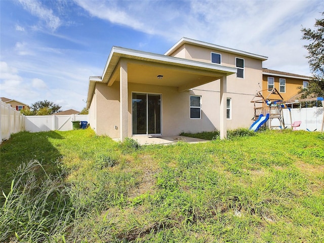 back of property featuring a yard