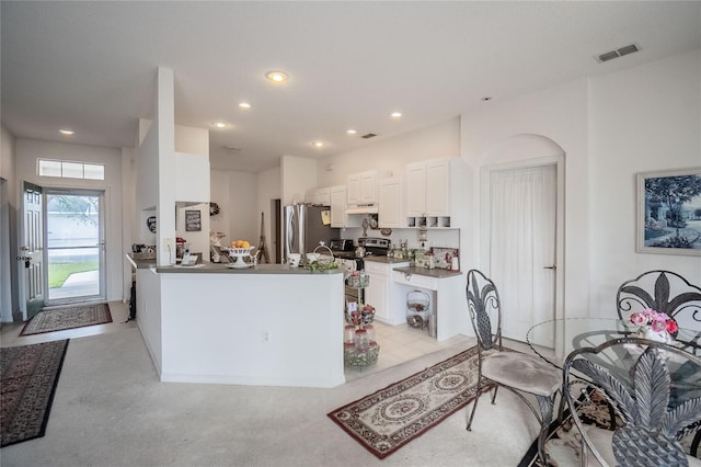 kitchen with kitchen peninsula, custom exhaust hood, stainless steel appliances, light colored carpet, and white cabinetry