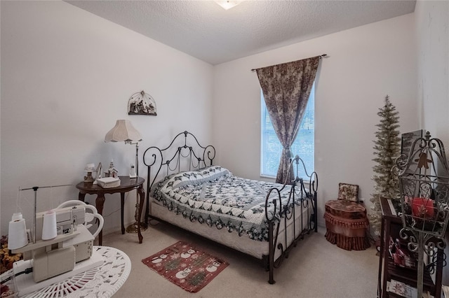 bedroom with a textured ceiling and carpet floors