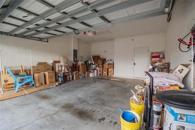 garage featuring electric panel and a garage door opener