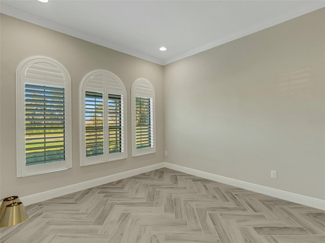 spare room featuring ornamental molding and light parquet flooring