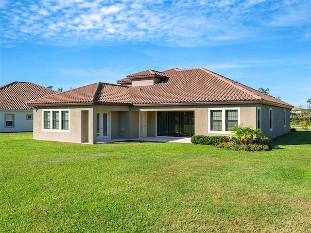 10469 Meadowrun Dr, Lithia, FL 33547 - rear view of house with a tiled roof, a yard, stucco siding, and a patio area