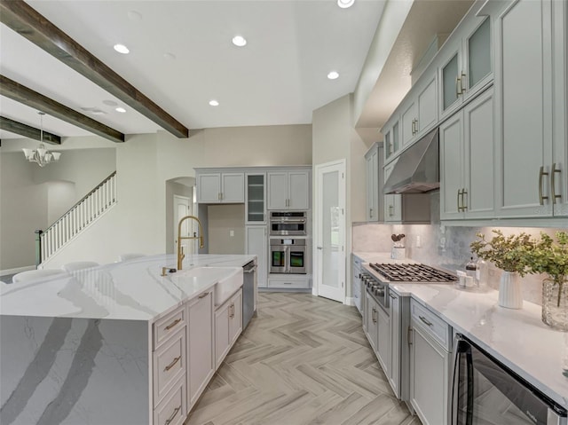 10469 Meadowrun Dr, Lithia, FL 33547 - kitchen with a sink, beverage cooler, appliances with stainless steel finishes, under cabinet range hood, and arched walkways
