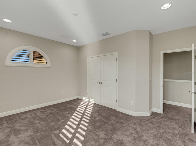 unfurnished bedroom featuring carpet and a closet