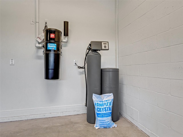 10469 Meadowrun Dr, Lithia, FL 33547 - detailed view of unfinished concrete flooring, a water softener system, and a central vacuum unit