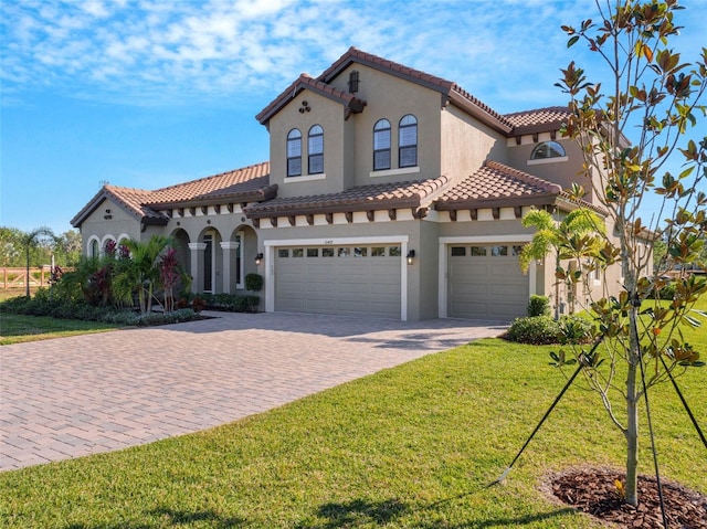 mediterranean / spanish-style house featuring a front lawn and a garage