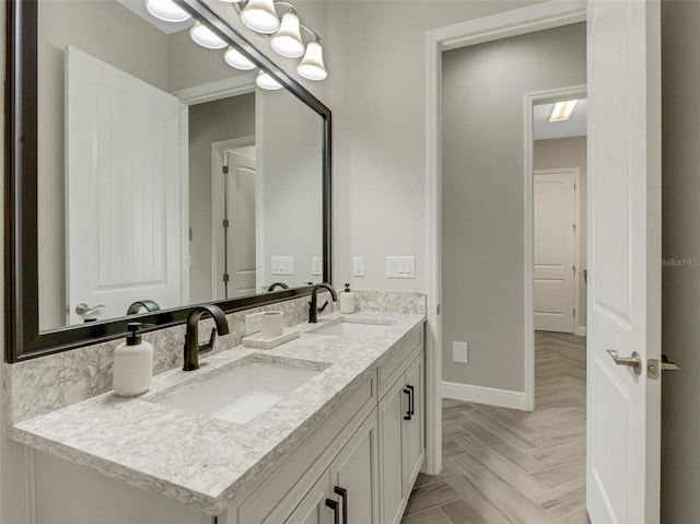 bathroom with parquet flooring and vanity