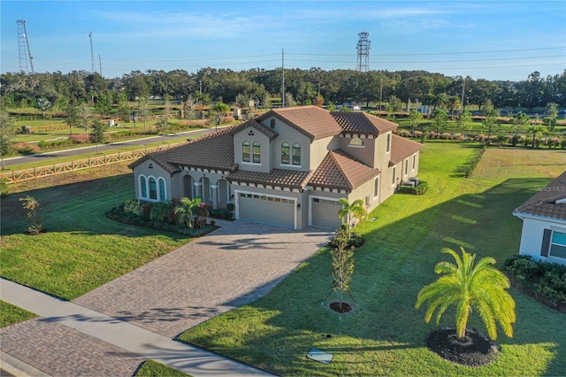 10469 Meadowrun Dr, Lithia, FL 33547 - mediterranean / spanish house with stucco siding, driveway, a tile roof, and a front lawn