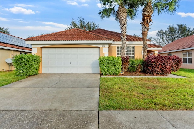 view of front facade featuring a front lawn and a garage