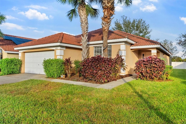 mediterranean / spanish house with a garage and a front yard