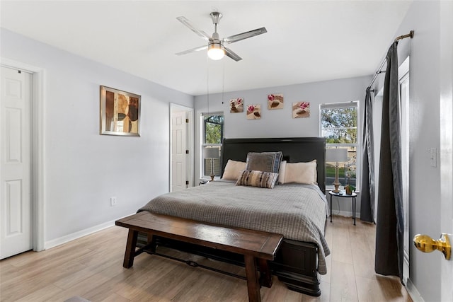 bedroom with light wood-type flooring, multiple windows, and ceiling fan