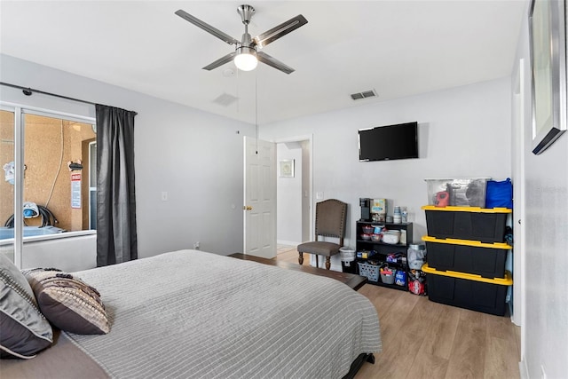 bedroom with ceiling fan and light hardwood / wood-style flooring