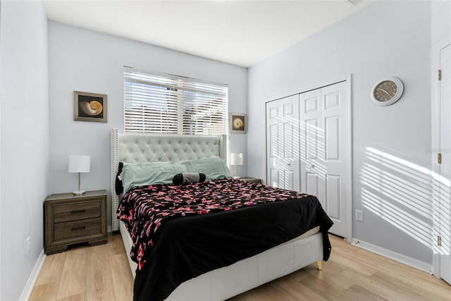 bedroom with light hardwood / wood-style flooring and a closet