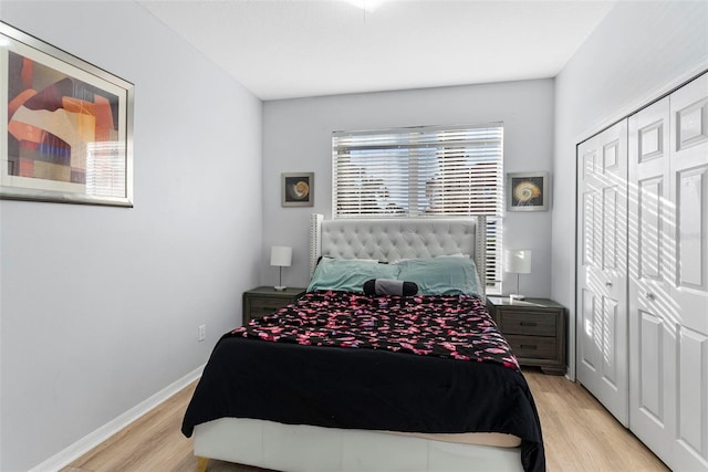 bedroom with light hardwood / wood-style flooring and a closet