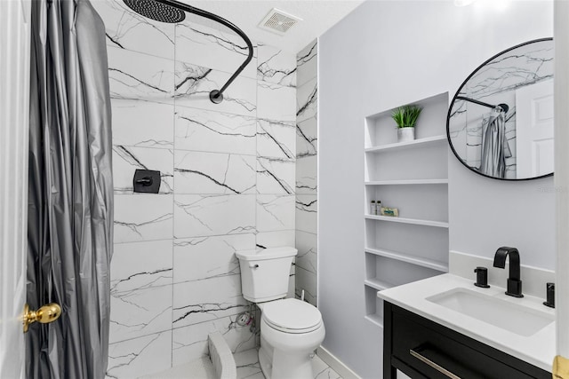 bathroom featuring vanity, toilet, and curtained shower