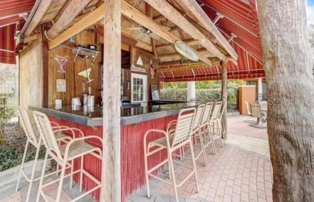 view of patio with an outdoor bar