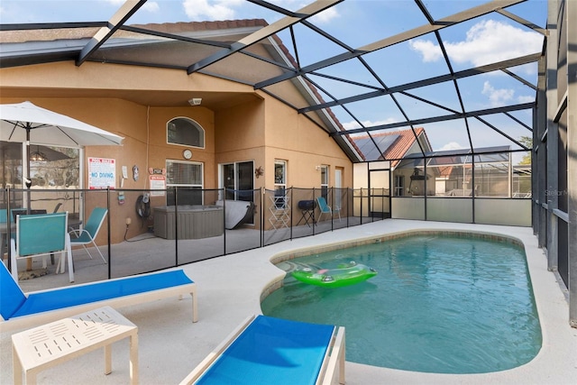 view of pool with a patio and glass enclosure