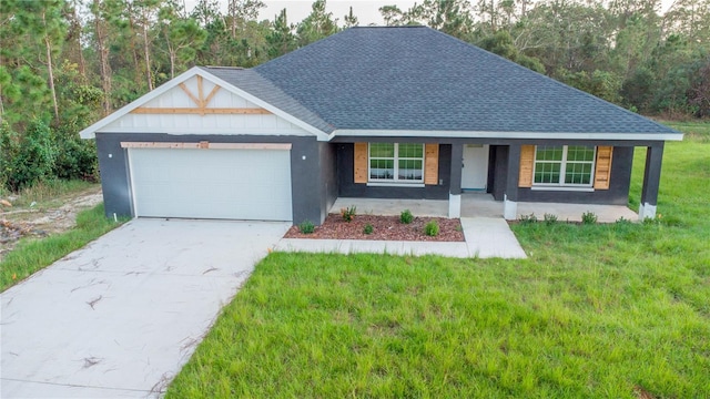 view of front of home featuring a front lawn, a porch, and a garage