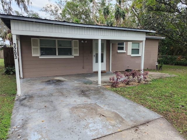 view of front facade with a front lawn and a carport