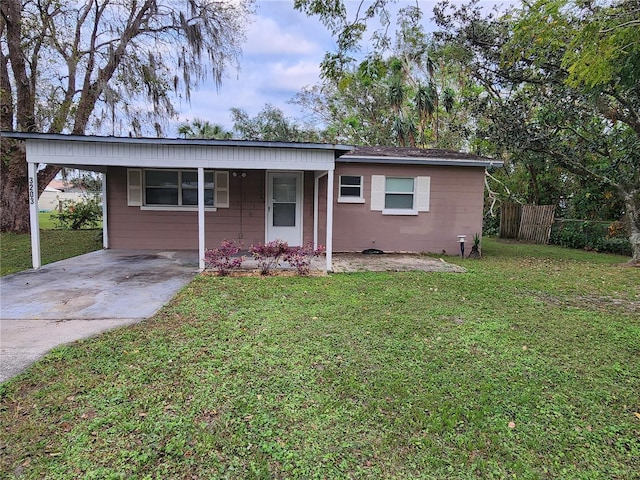 single story home with a front yard and a carport