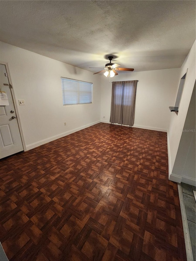 spare room featuring ceiling fan and a textured ceiling