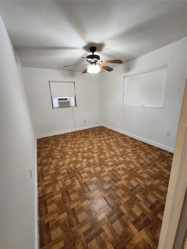 empty room with ceiling fan, cooling unit, and dark parquet flooring