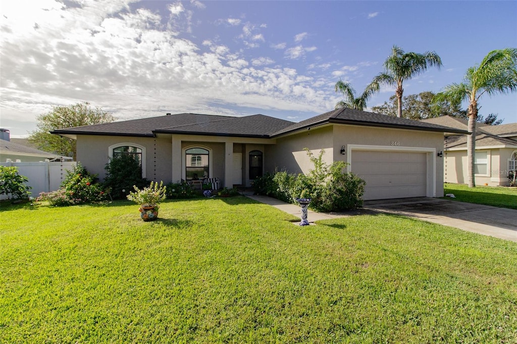 ranch-style home with a front yard and a garage