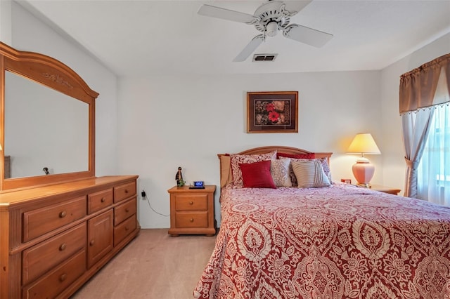 bedroom with ceiling fan and light carpet