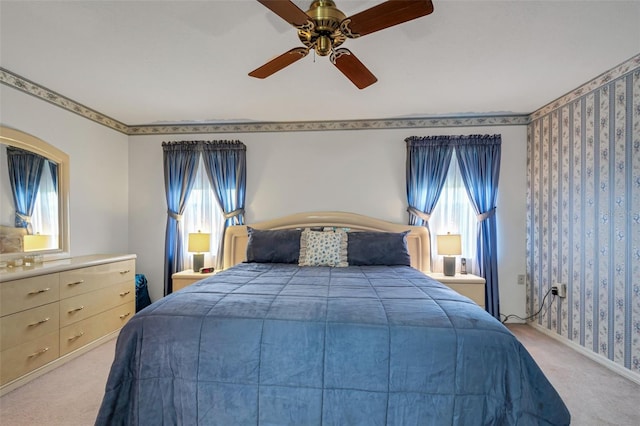 carpeted bedroom with multiple windows and ceiling fan