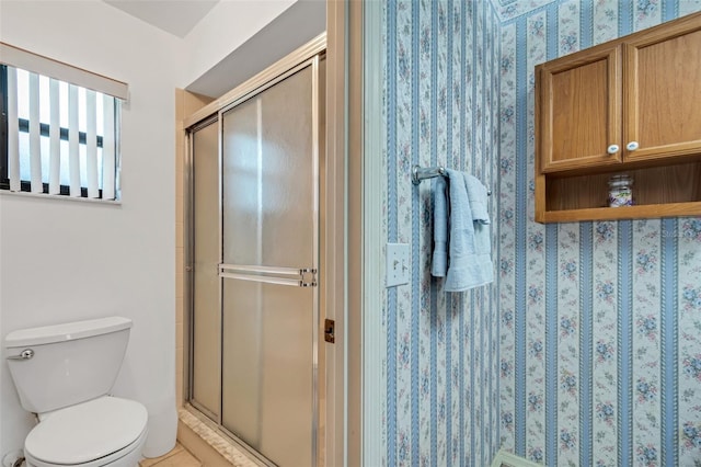 bathroom with an enclosed shower and toilet