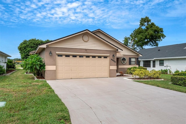 ranch-style house featuring a garage and a front lawn