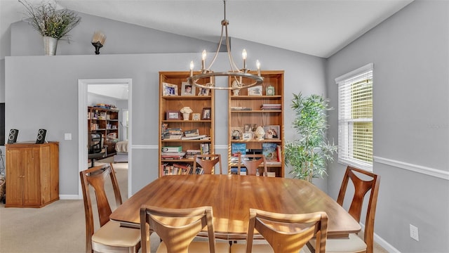 carpeted dining room with an inviting chandelier and lofted ceiling