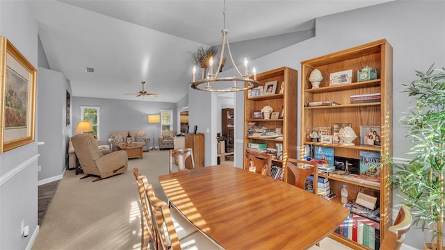 dining area with ceiling fan with notable chandelier, light carpet, and vaulted ceiling